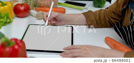 Female looking recipe on mock-up tablet while 66498001