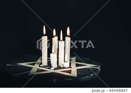 Six burning candles and the Star of David against 66499897