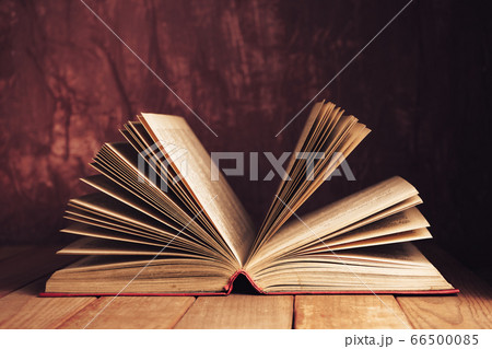 Close up Beautiful ancient open old book on a red Close up Beautiful ancient open old book on a red 66500085