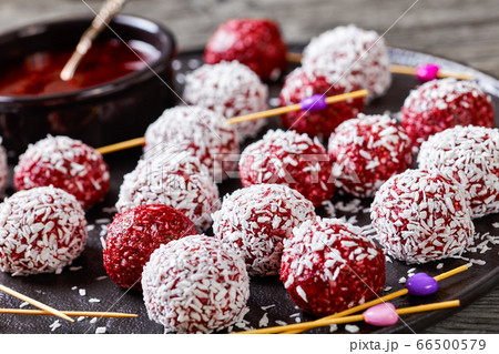 Energy berry balls on a black plate, close-up 66500579