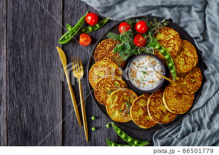 green pea and oatmeal pancakes on black plate 66501779