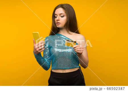 Lady buying online with a credit card and smart 66502387