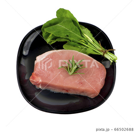 Pieces of raw pork steak in black plate with Pieces of raw pork steak in black plate with 66502688