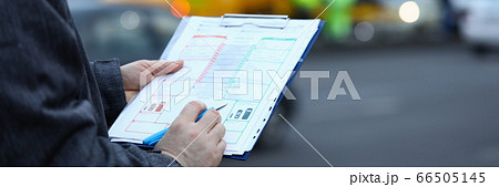 Man fills out insurance form on movement vehicle 66505145