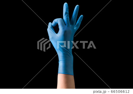 Doctor's hand in sterile medical gloves in gesture of okay isolated on black Doctor's hand in sterile medical gloves in gesture of okay isolated on black 66506612