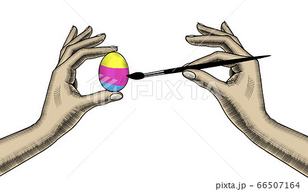 A woman coloring an egg for Easter. 66507164