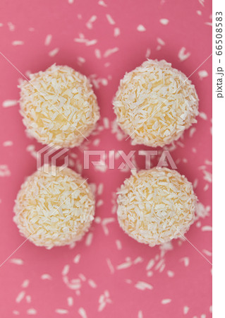 Candies covered by shredded coconut. 66508583