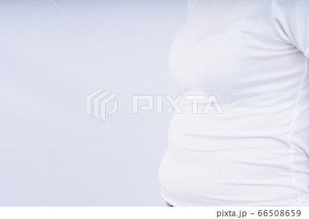 Close-up woman showing excessive belly fat, Close-up woman showing excessive belly fat, 66508659