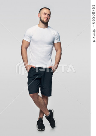 Full length man standing casually looking to side 66508761