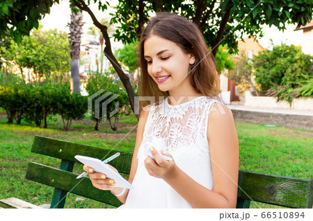 Cute girl is holding a pen, a notepad and crumpled Cute girl is holding a pen, a notepad and crumpled 66510894
