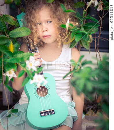 Portrait of a cute girl with ukulele Portrait of a cute girl with ukulele 66511818
