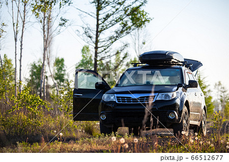 Subaru Forester with roof box at dirt road in the 66512677