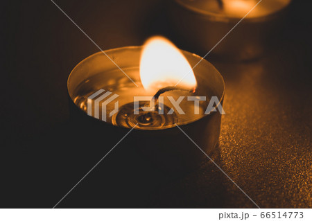 three candles in the dark, close up 66514773