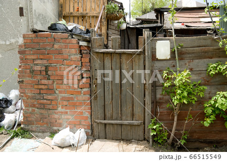 Background old wooden door, brick wall and trash 66515549