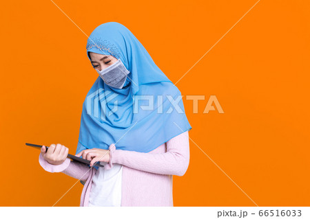 Asian Muslim woman wearing medical mask in hijab 66516033