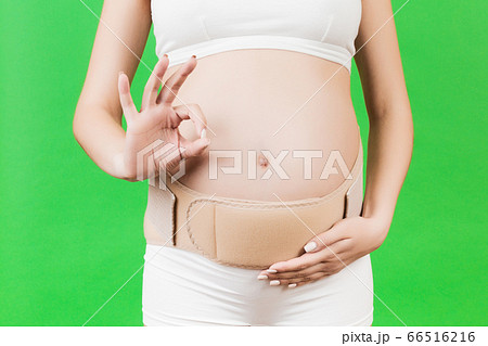 Close up of pregnant woman in underwear wearing 66516216