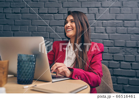 Amazing young woman working at her laptop 66516461