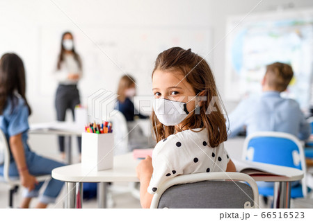 Child with face mask back at school after covid-19 quarantine and lockdown. Child with face mask back at school after covid-19 quarantine and lockdown. 66516523