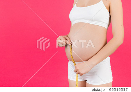 Cropped image of pregnant woman in white underwear 66516557