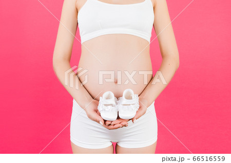 Close up of pregnant woman in white underwear 66516559