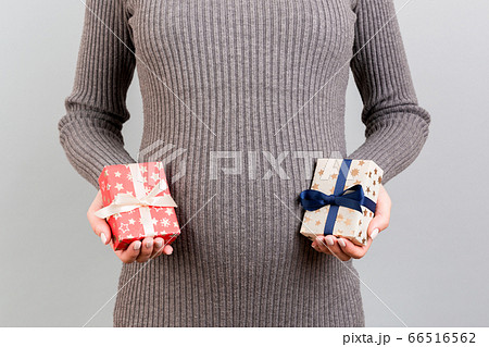 Close up of two gift boxes in pregnant woman's 66516562