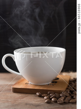 Steam hot coffee white cup on wooden plate Steam hot coffee white cup on wooden plate 66516908
