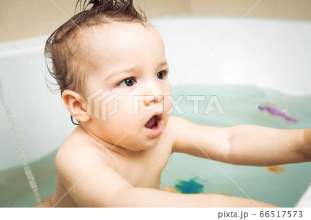 adorable little baby boy washing in bath adorable little baby boy washing in bath 66517573