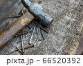 Old hammer and nails on wood top view. Carpentry workshop 66520392