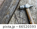 Old hammer and nails on wood top view. Carpentry workshop 66520393
