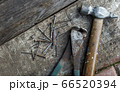 Old hammer and nails on wood top view. Carpentry workshop 66520394