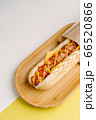 Grilled Hot Dog with cheese on wooden plate 66520866