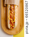 Grilled Hot Dog with cheese on wooden plate top view 66520867