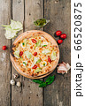Caesar Italian pizza with cheese and quail eggs on wooden background 66520875