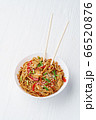 Udon noodles with chicken on white wooden background 66520876