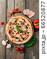 Italian pizza with bacon, sausage and mushrooms on wooden background 66520877