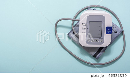 Device for measuring blood pressure on a blue medical background. Copy space. 66521339