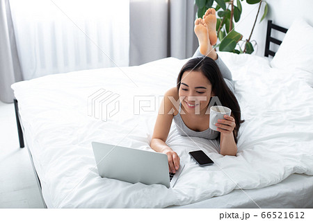 Happy woman spending good morning with gadgets Happy woman spending good morning with gadgets 66521612