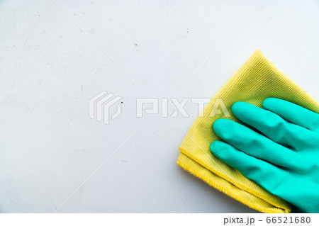 hand in green rubber glove wipes dusty table with a rag hand in green rubber glove wipes dusty table with a rag 66521680