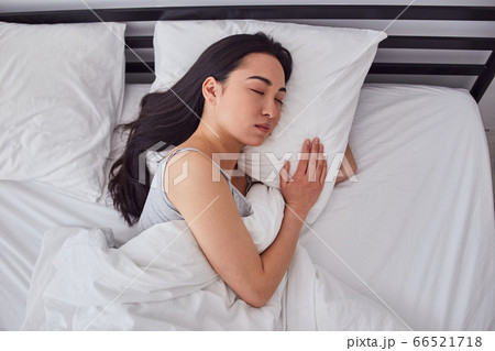 Charming Asian lady resting in her bad Charming Asian lady resting in her bad 66521718