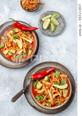 Aztec soup. Mexican sopa azteca with fried tortilla . Top view 66521807