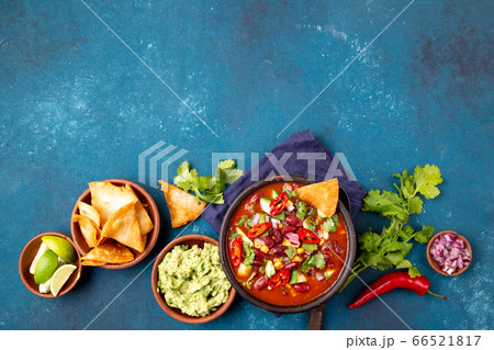 Mexican food concept background with chile black bean soup, guacamole and nachos totopos. Top view 66521817