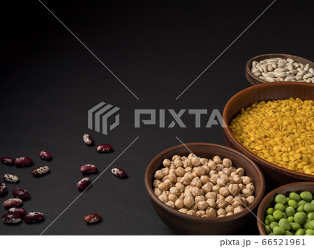 Beans in a clay pot on a black background. Beans in a clay pot on a black background. 66521961