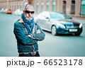 old modern man walks in the street, on the background of street and cars old modern man walks in the street, on the background of street and cars 66523178