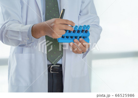 Doctor hand holding blood tube for test in lab or Doctor hand holding blood tube for test in lab or 66525986