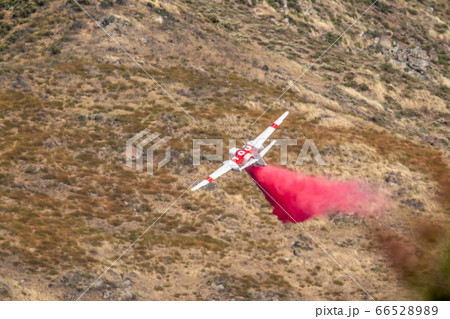 Airplane Dropping Fire Retardant on Wildfire Airplane Dropping Fire Retardant on Wildfire 66528989