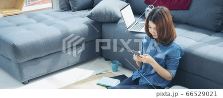Banner asian woman using smartphone reading online 66529021