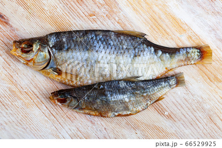 Air-dried salted roach fish on wooden background Air-dried salted roach fish on wooden background 66529925