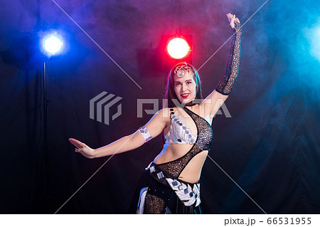 Spirituality dance. Beautiful sexy woman with luxury glossy eastern make-up dancing tribal fusion. Belly dance. Spirituality dance. Beautiful sexy woman with luxury glossy eastern make-up dancing tribal fusion. Belly dance. 66531955