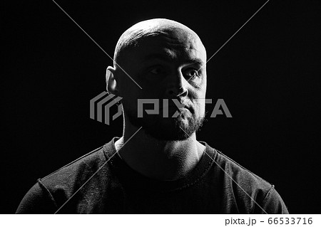 Black and white photo of the bald man on black background Black and white photo of the bald man on black background 66533716