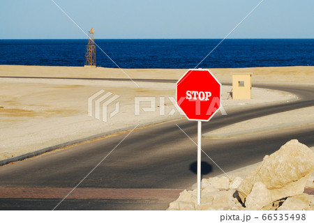 Sand beach coast with red Stop sign Sand beach coast with red Stop sign 66535498